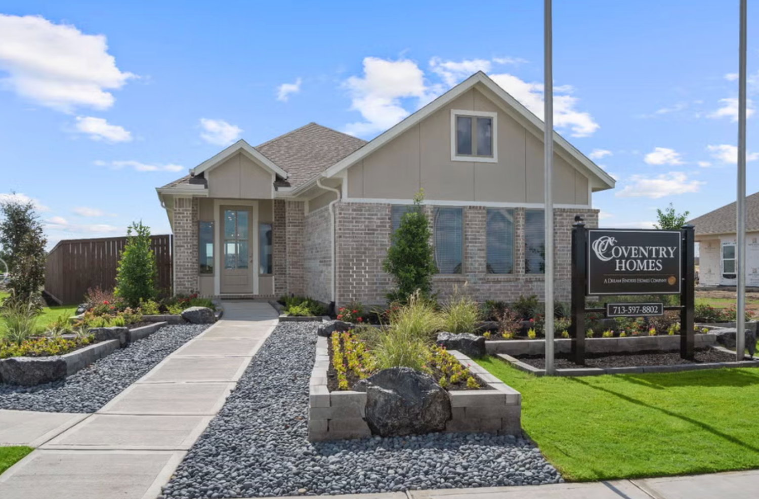 Coventry Homes model home exterior with builder name sign in Creekhaven Iowa Colony, TX