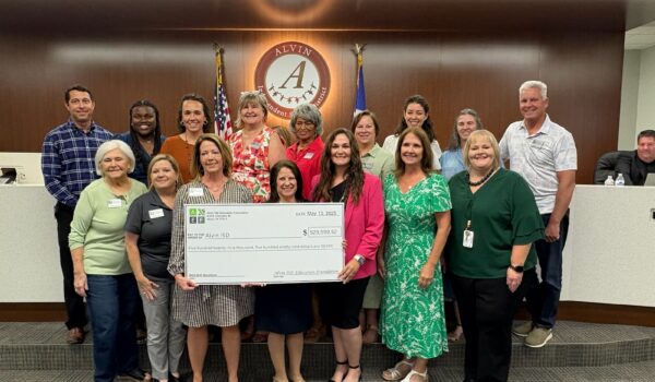 Group of people receiving check for Alvin ISD