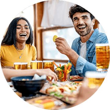 People enjoying food and beer at a restaurant