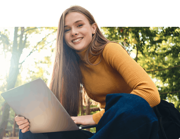 Young girl with laptop outdoors